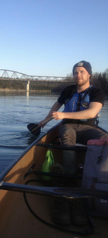 Photo of Conor Kerr paddling a canoe